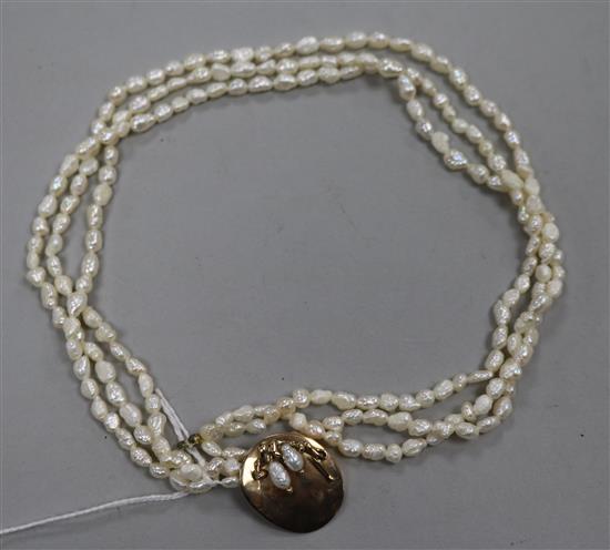 A triple strand freshwater pearl necklace with yellow metal clasp, 41.5cm.